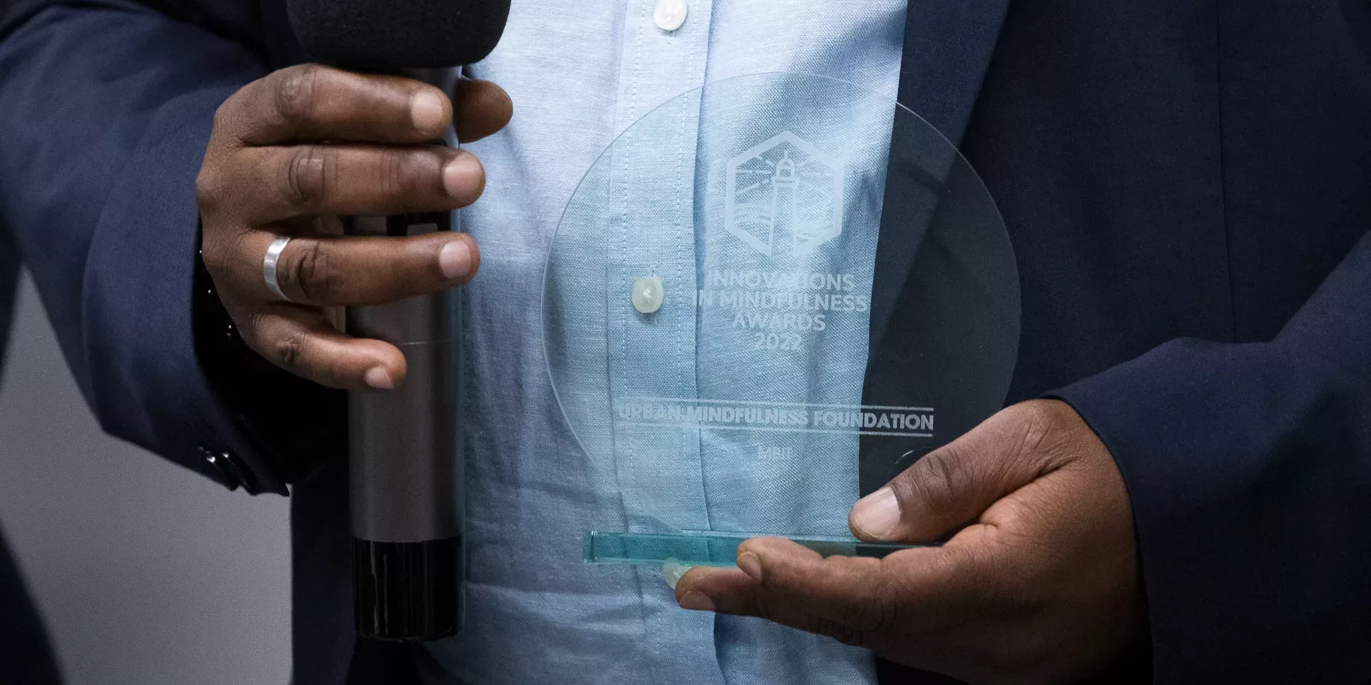 Photo of transparent award being held in hands.